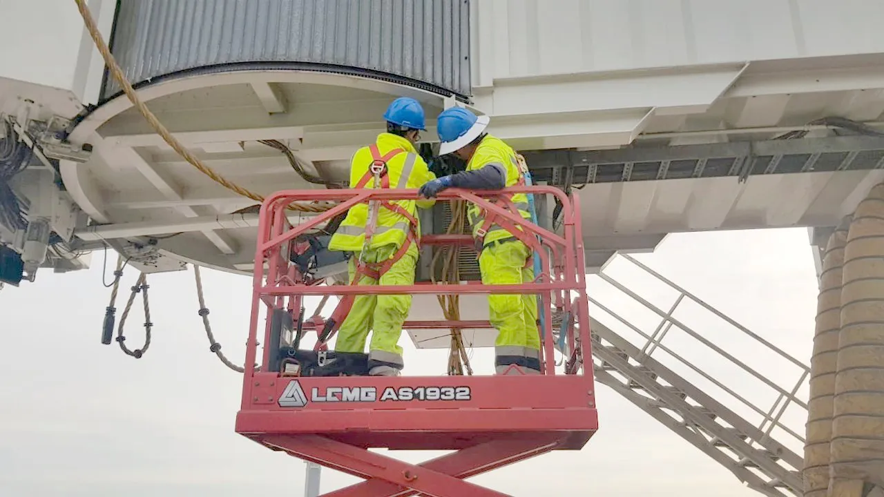 APS LATAM crew working under a boarding bridge from an elevating work platform