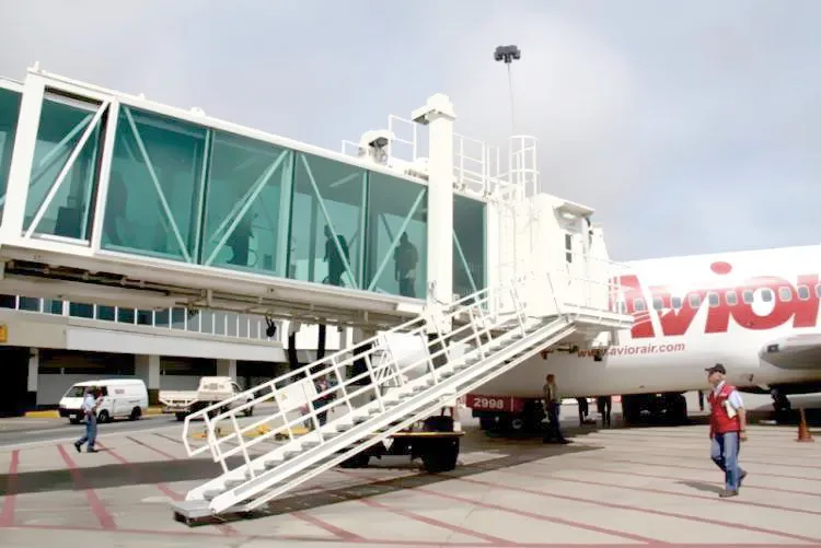 Boarding bridge docked to an aircraft at an airport in Venezuela